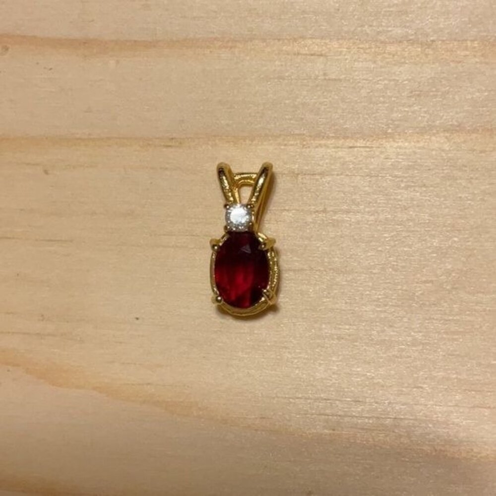 Gold-Tone Oval Red Gemstone Pendant With Diamond Accent